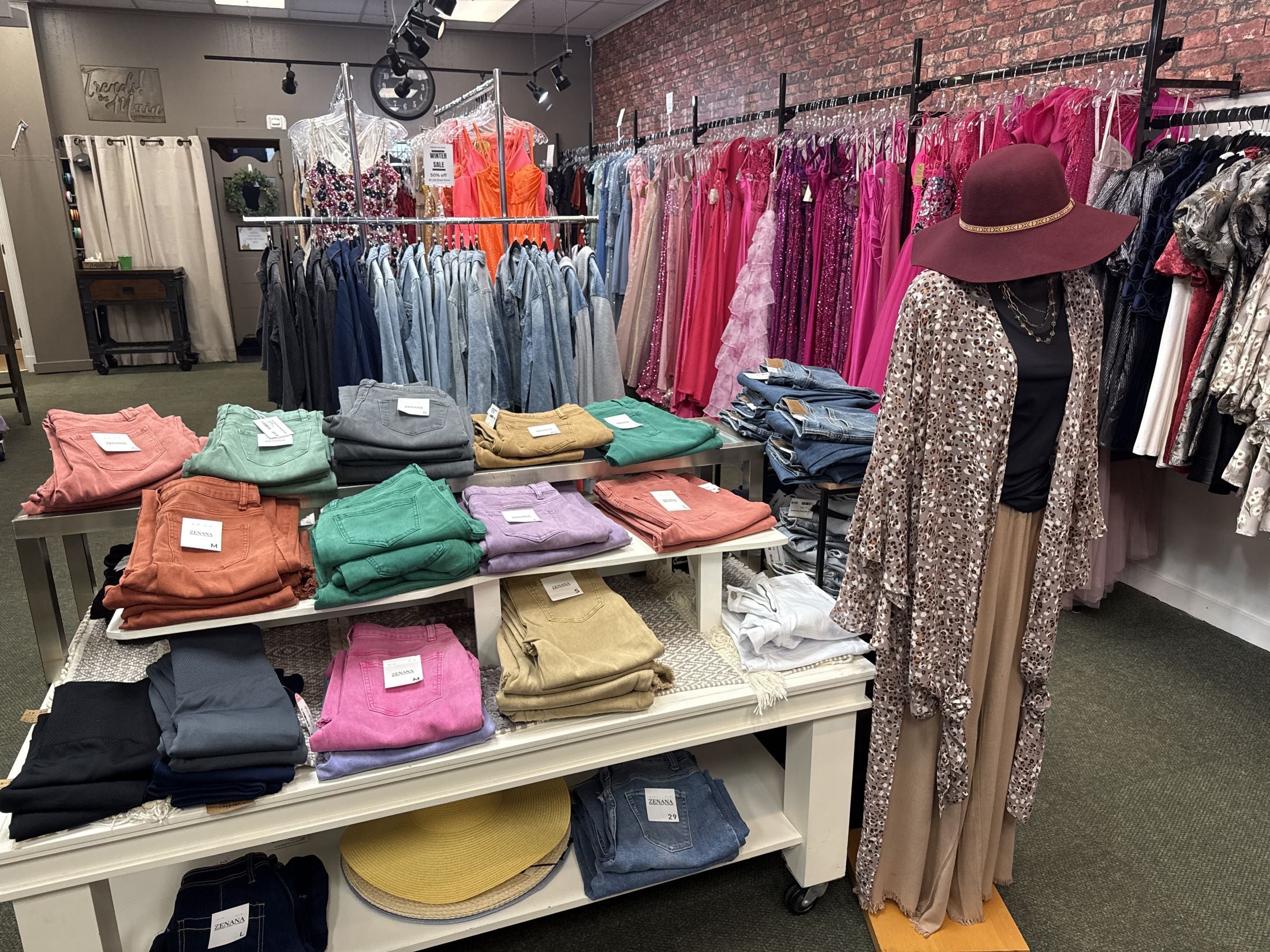 Colorful women’s boutique clothing display featuring stylish outfits and accessories in a trendy local boutique.